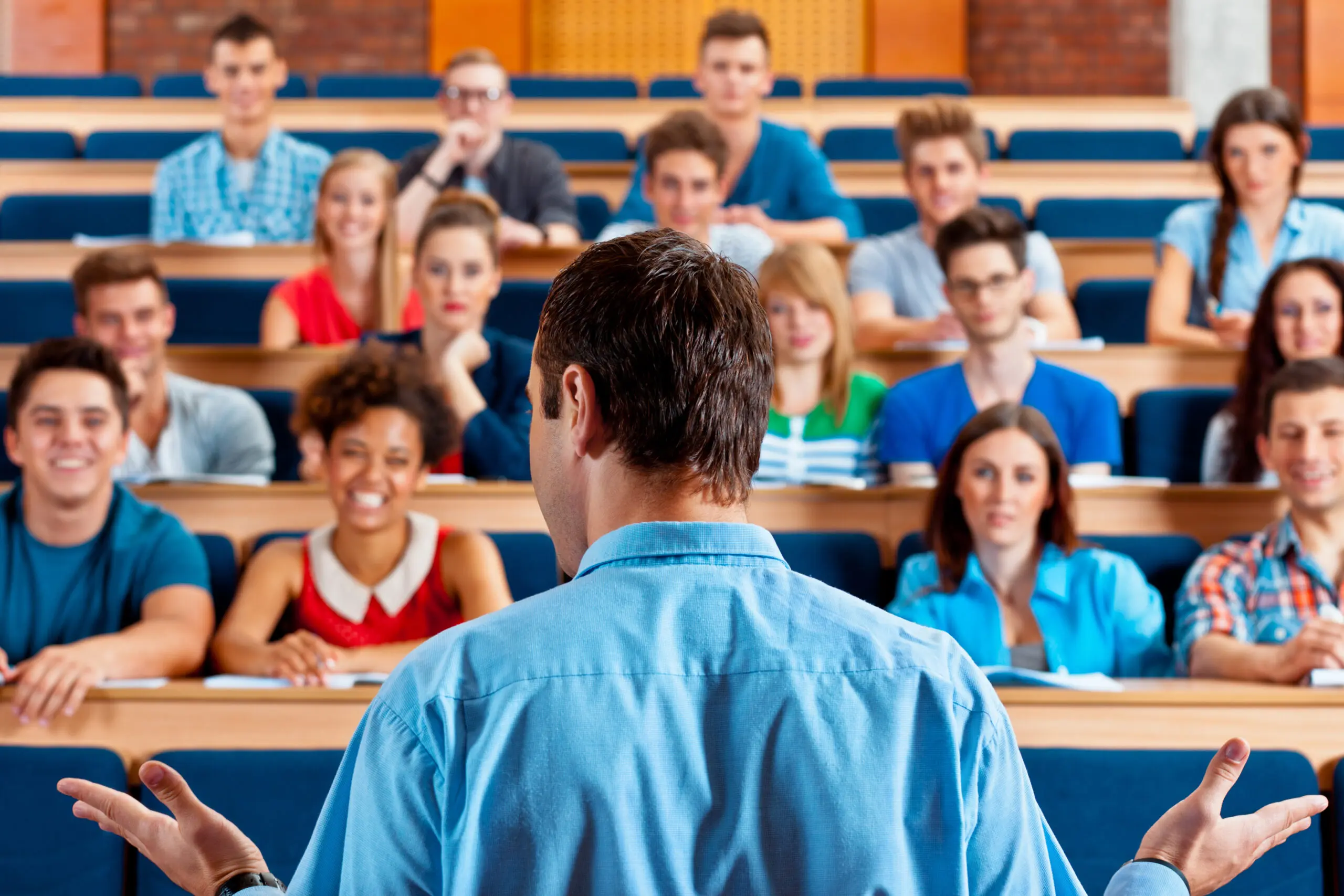 Professor teaching students in a lecture hall.