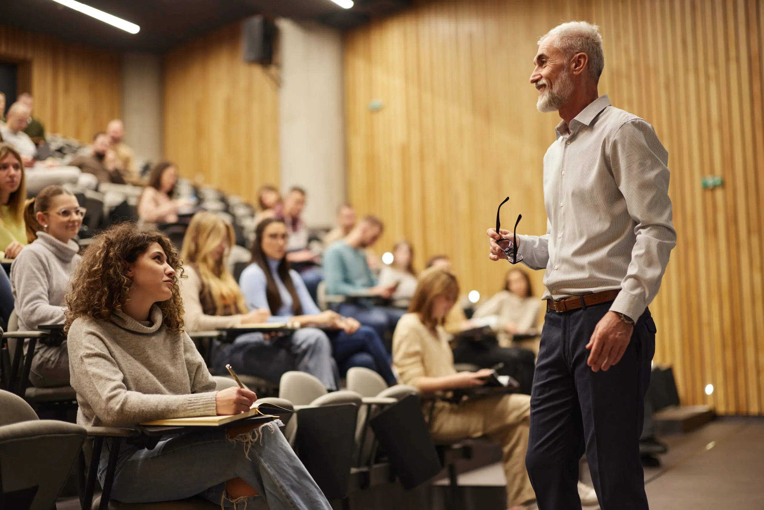 Professor lecturing students in a classroom.