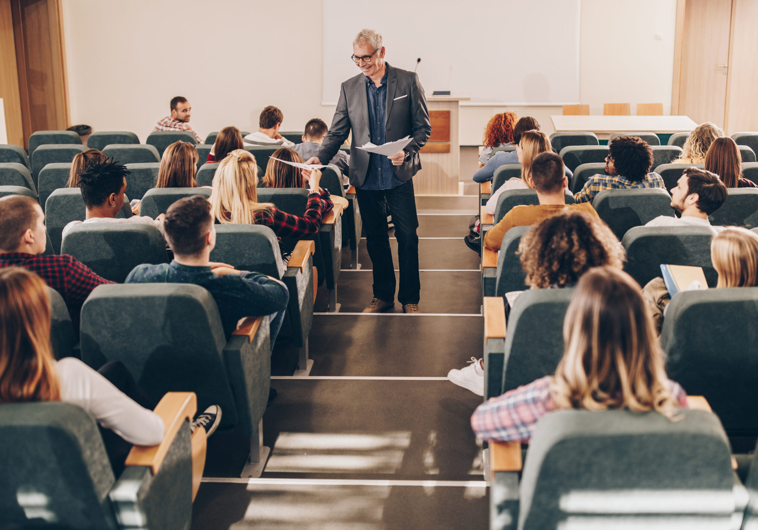 Lecture hall with students and a professor.