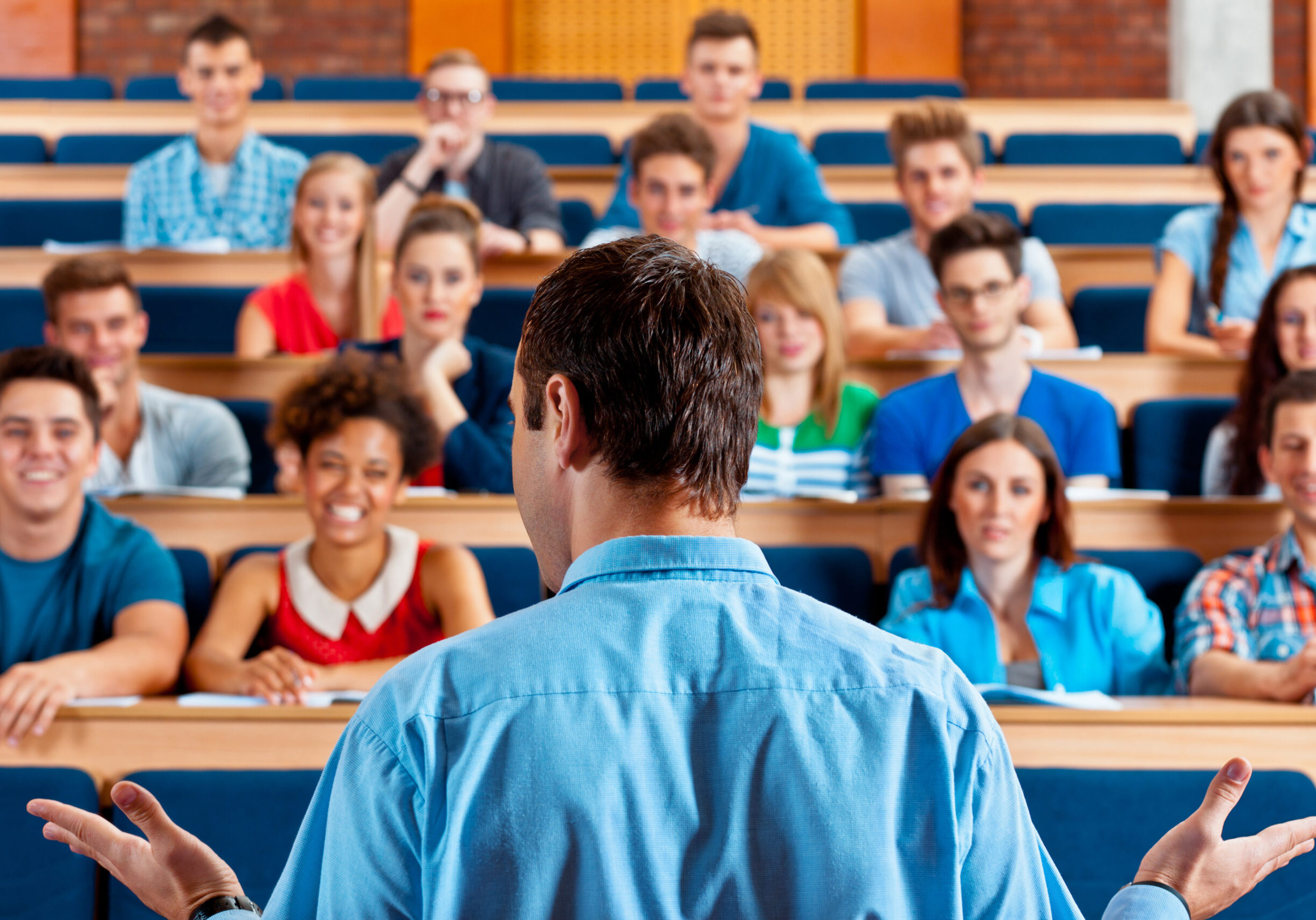 Professor teaching students in a lecture hall.