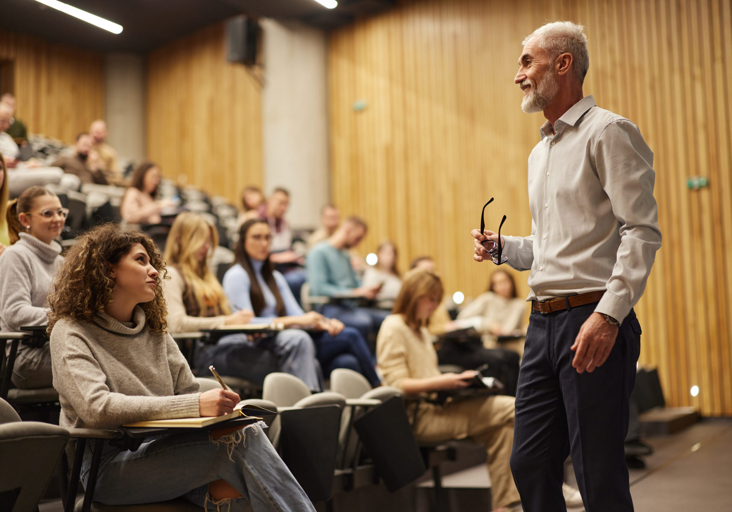 Professor lecturing students in a classroom.